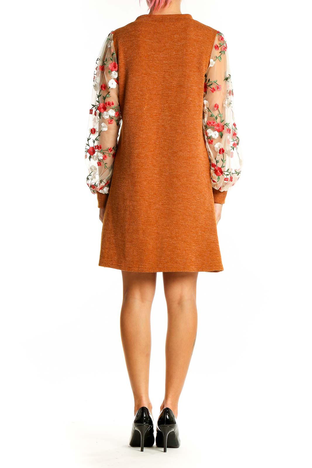 Back view of orange knit dress showing floral mesh sleeves