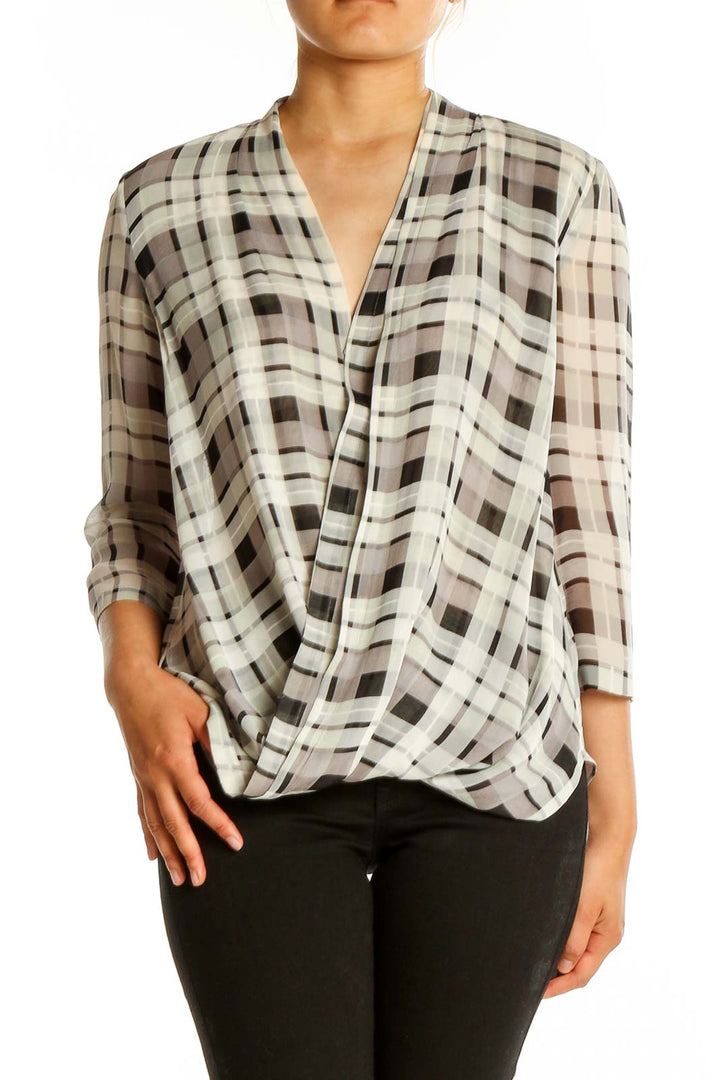 Front view of Babaton white and brown plaid silk blouse with wrap-style front