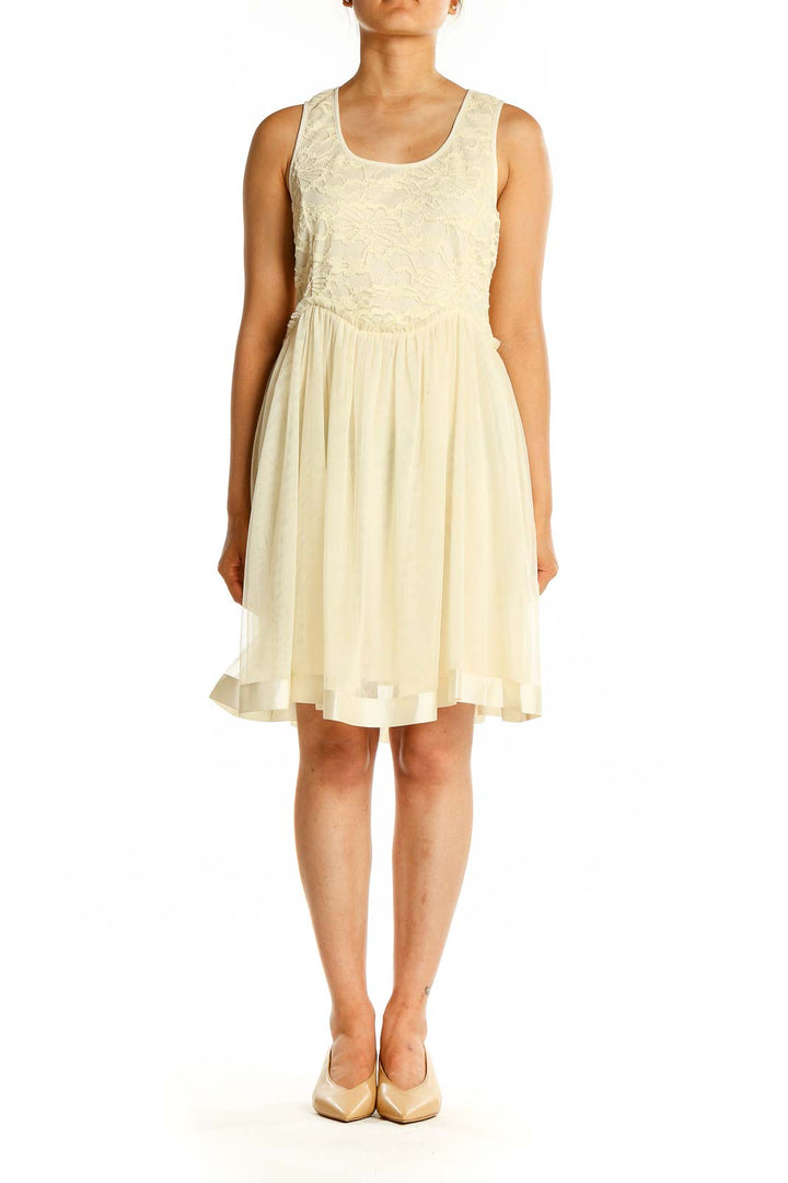 Front view of cream a'reve dress with lace bodice and flowy skirt