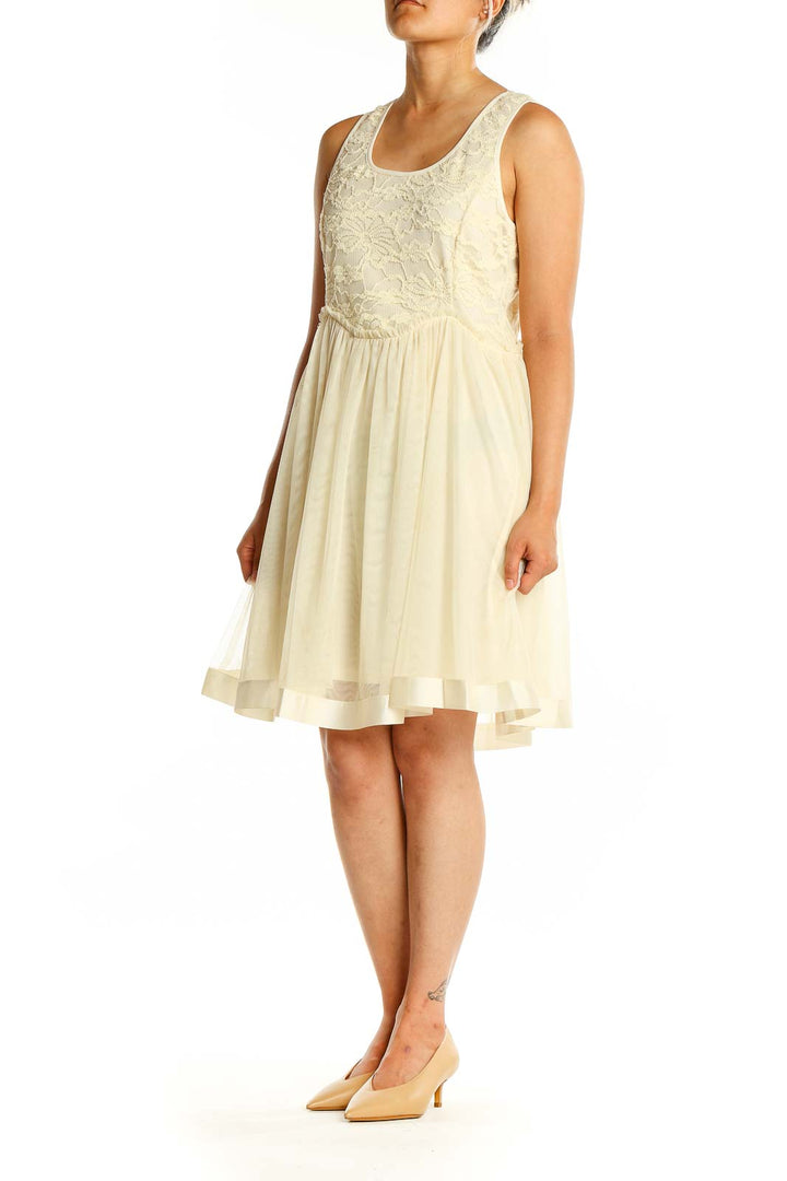 Front view of cream a'reve dress with lace bodice and flowy skirt