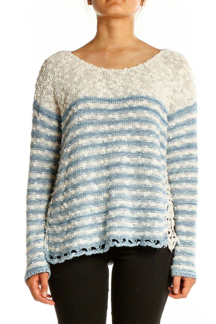 Front view of Free People blue and white striped knit sweater with scalloped hem