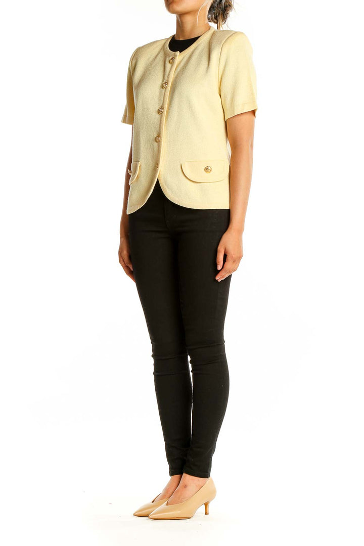 Front view of cream short-sleeve knit cardigan with gold-tone buttons