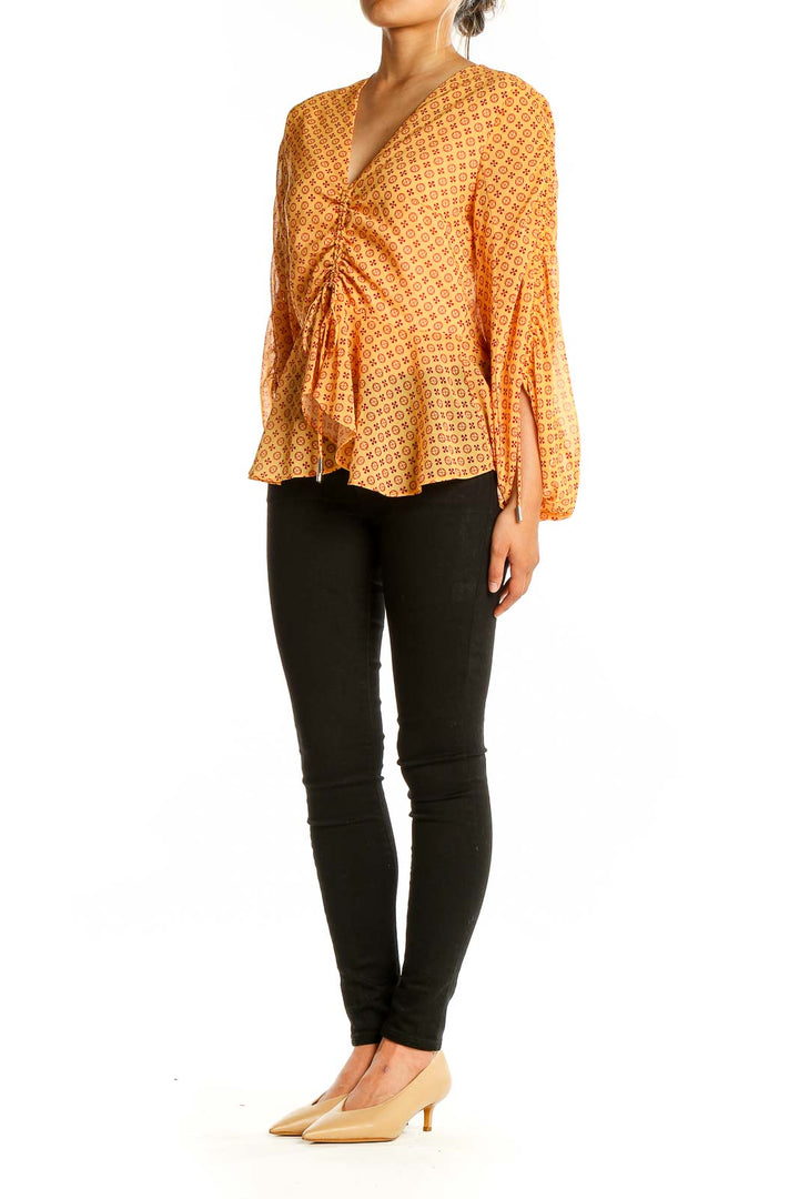 Front view of SilkRoll yellow geometric print peplum blouse with V-neck and balloon sleeves