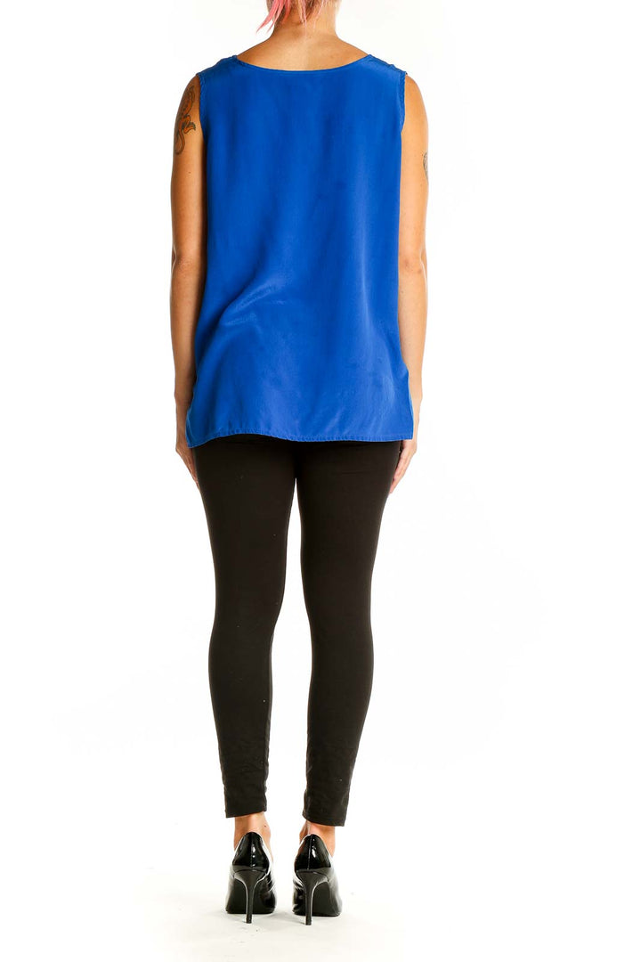 Back view of royal blue sleeveless silk blouse showing flowing silhouette