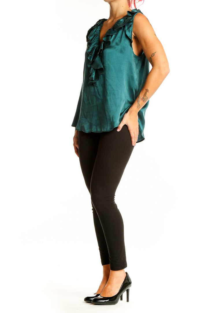 Front view of emerald green silk blouse with ruffled V-neckline