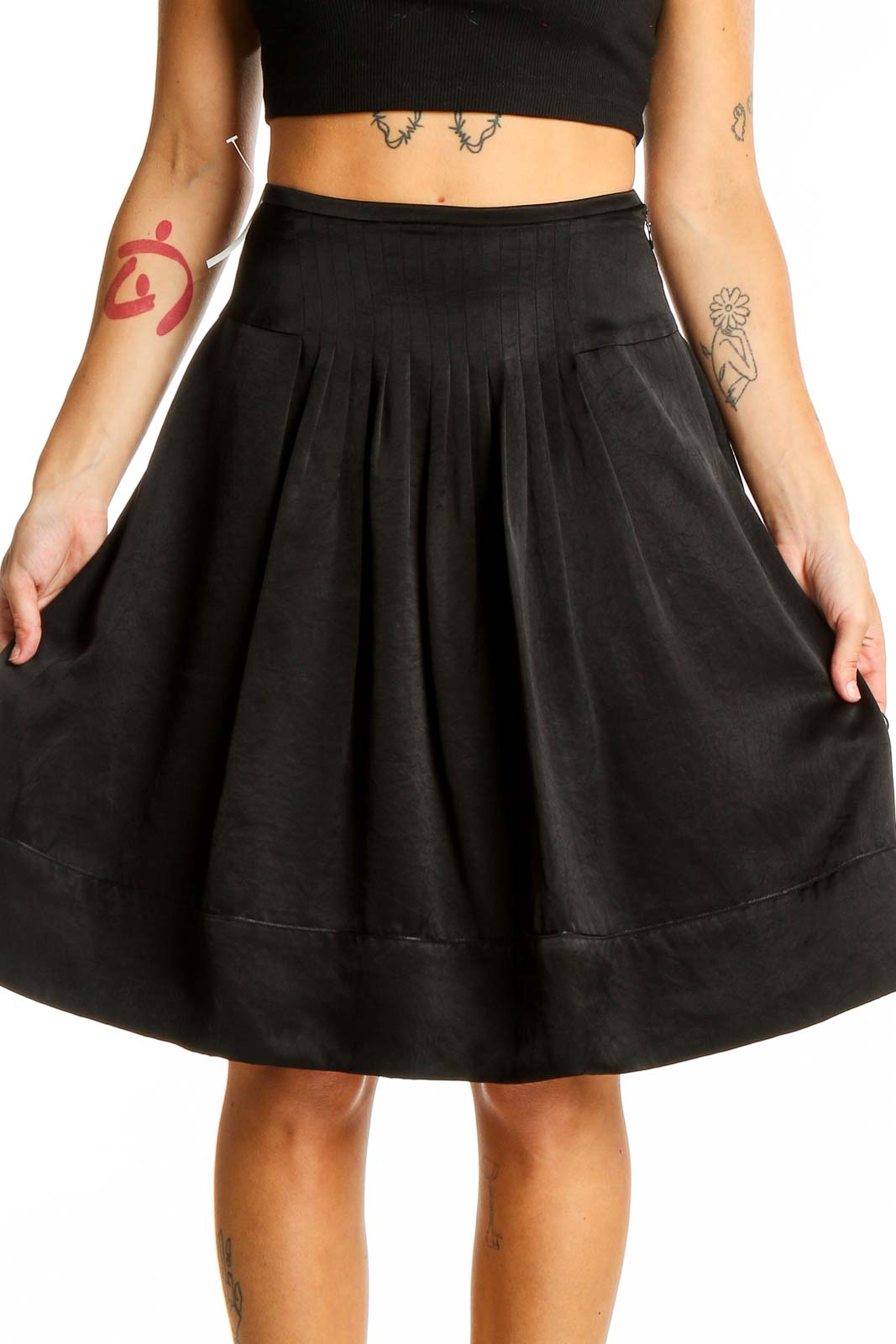 Front view of Ined black pleated A-line midi skirt on model