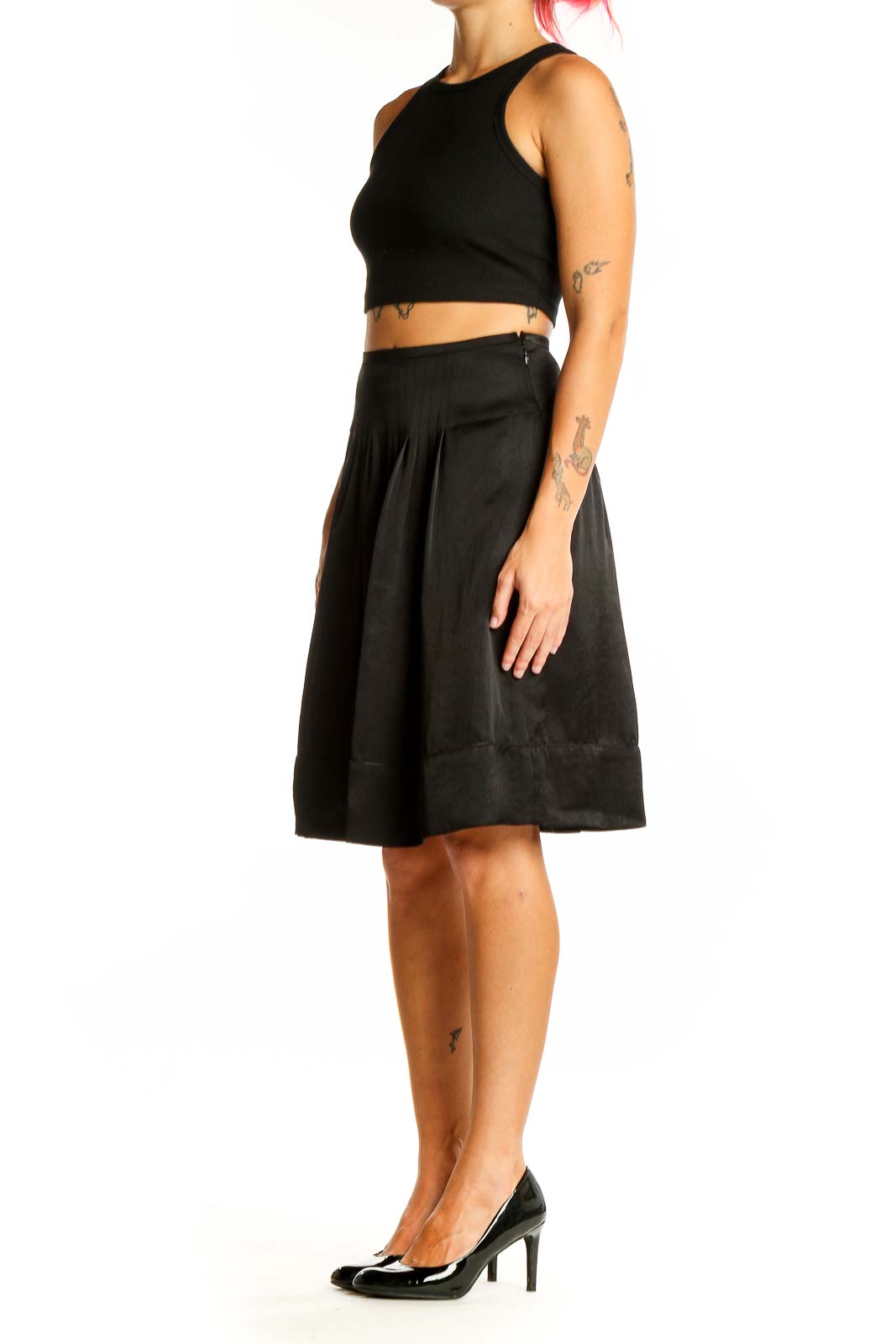 Front view of Ined black pleated A-line midi skirt on model