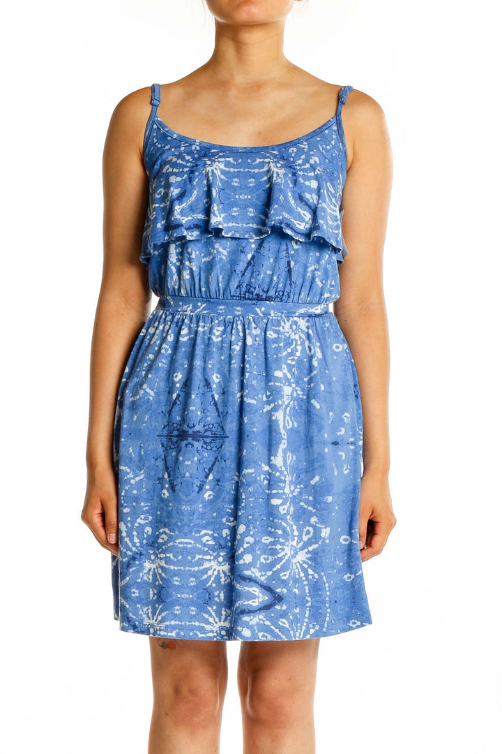 Front view of blue floral sundress with ruffle overlay and adjustable straps