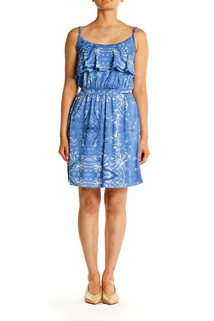 Front view of blue floral sundress with ruffle overlay and adjustable straps