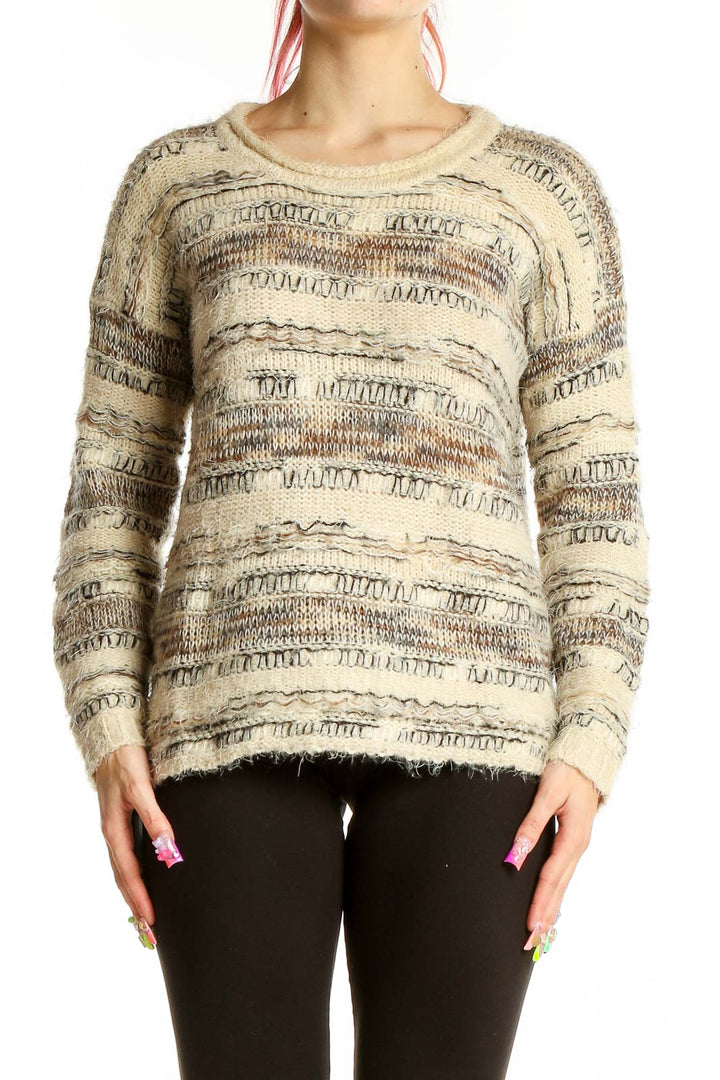 Front view of Sisters beige textured knit sweater with intricate patterns