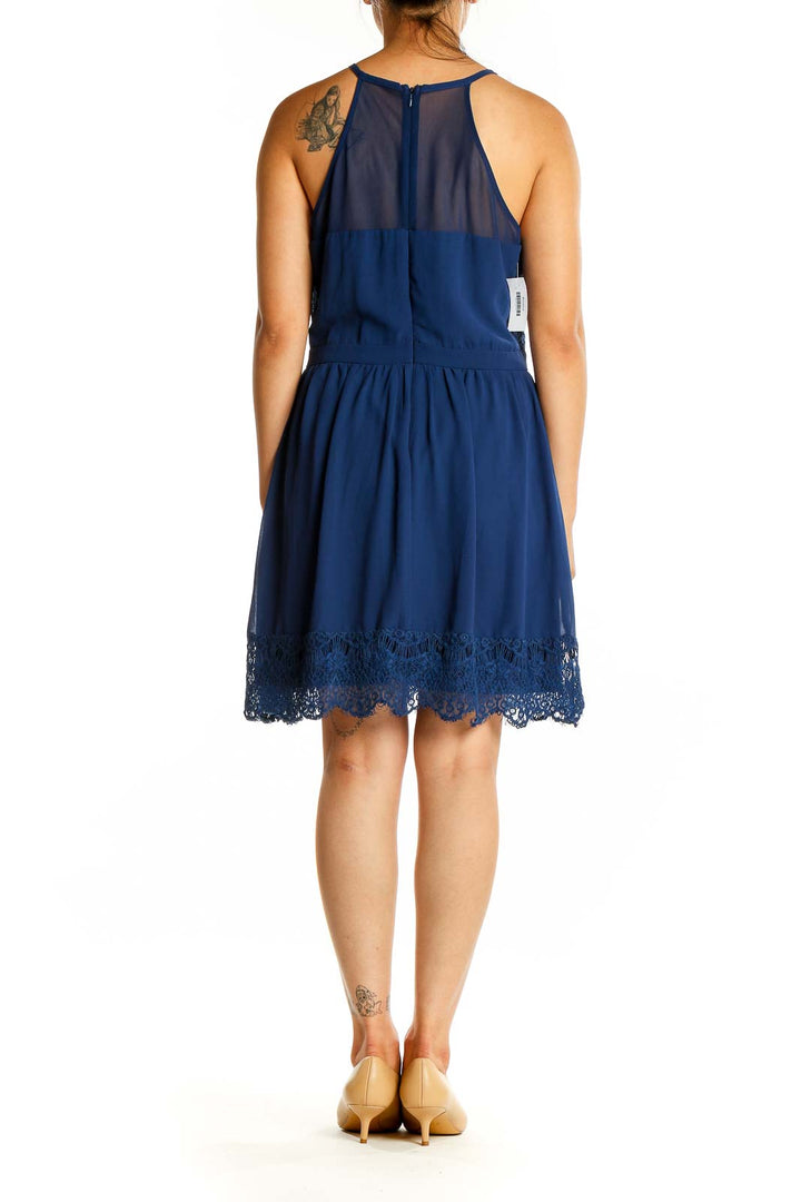 Back view of Francesca's navy halter dress showing sheer panel and zipper closure