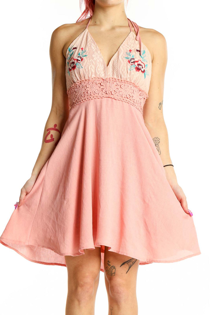 Front view of Flying Tomato pink halter sundress with floral embroidery