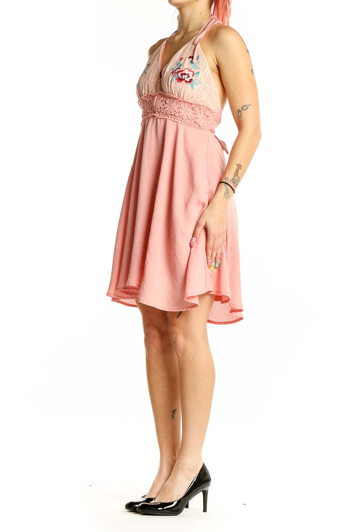 Front view of Flying Tomato pink halter sundress with floral embroidery