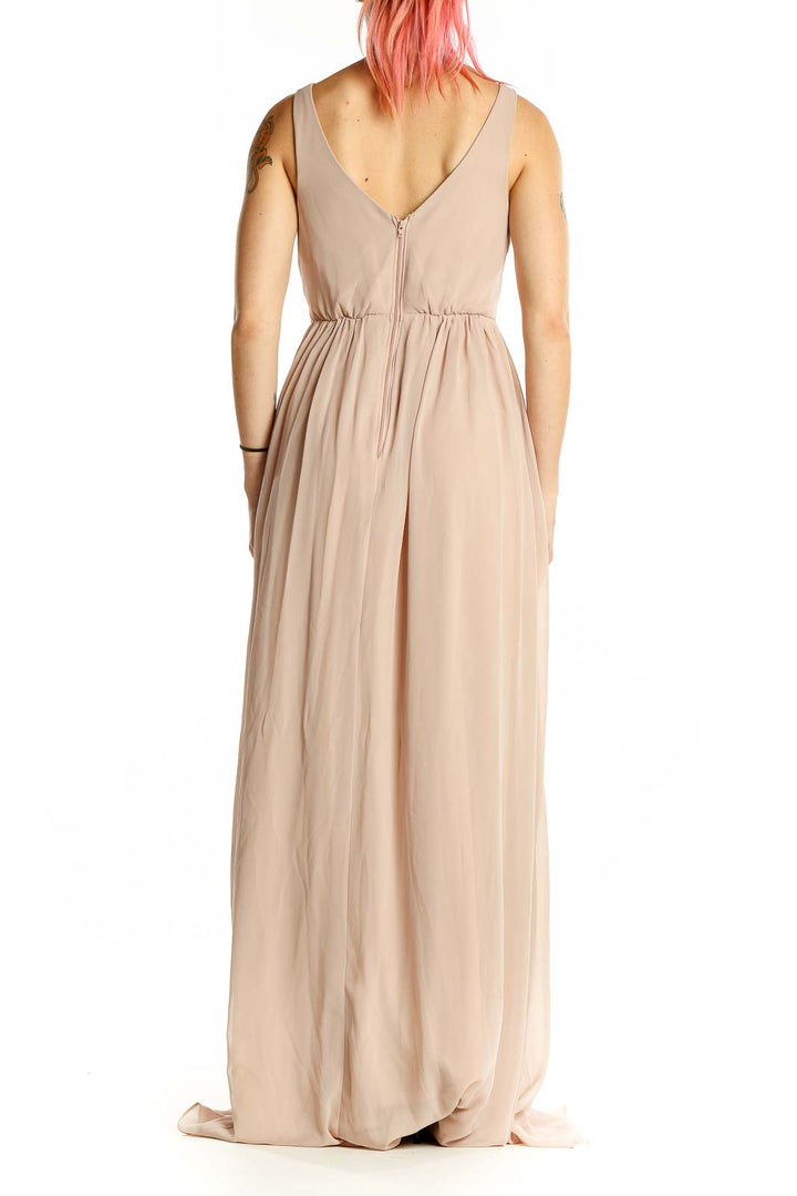 Back view of blush Birdy Grey V-neck maxi bridesmaid dress showing low V-back