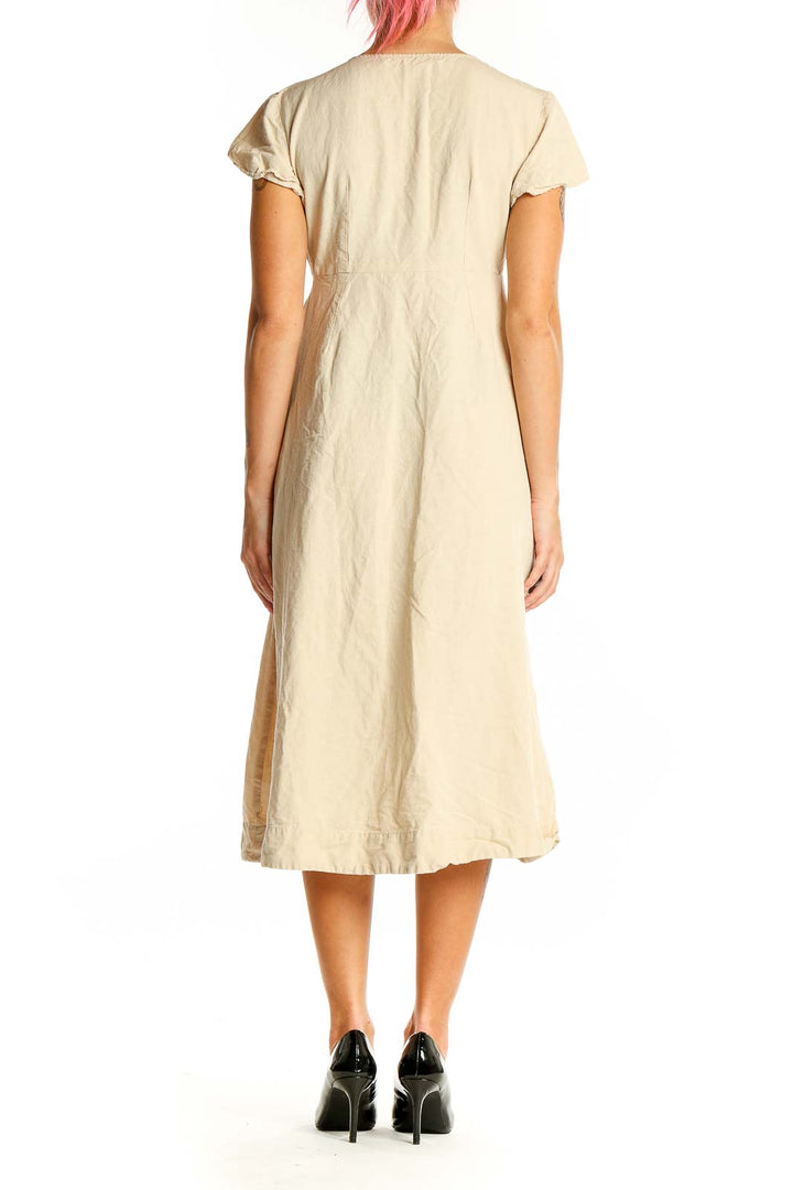 Back view of beige MNG midi dress showing A-line silhouette