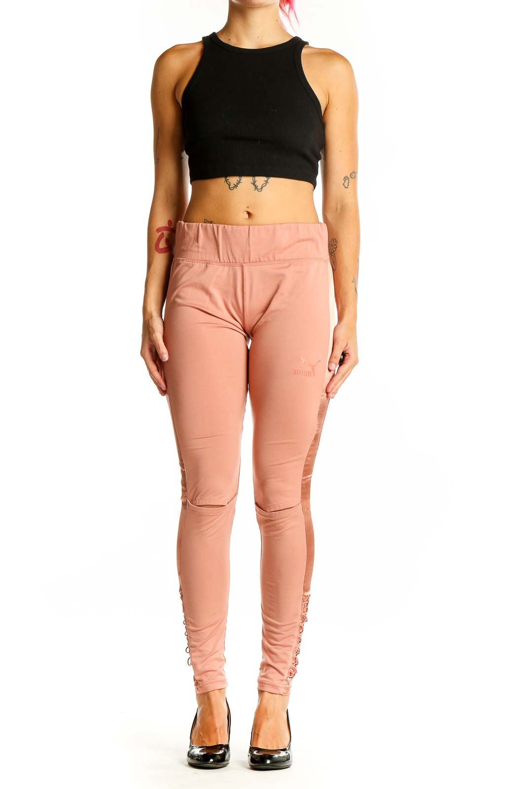 Front view of Puma peach high-waisted leggings with lace-up sides