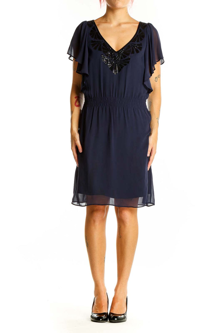 Front view of navy chiffon cocktail dress with flutter sleeves and sequin embellished V-neckline