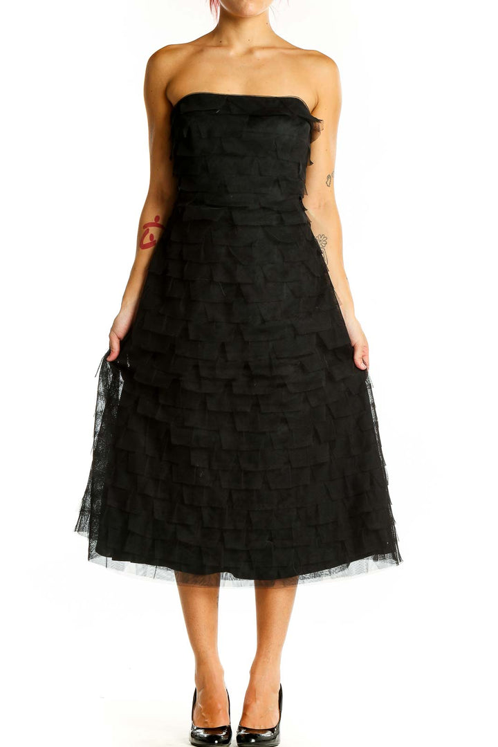 Front view of black strapless BCBG MaxAzria midi dress with tiered tulle skirt