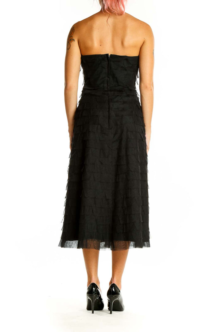 Back view of black strapless BCBG MaxAzria midi dress showing zipper closure