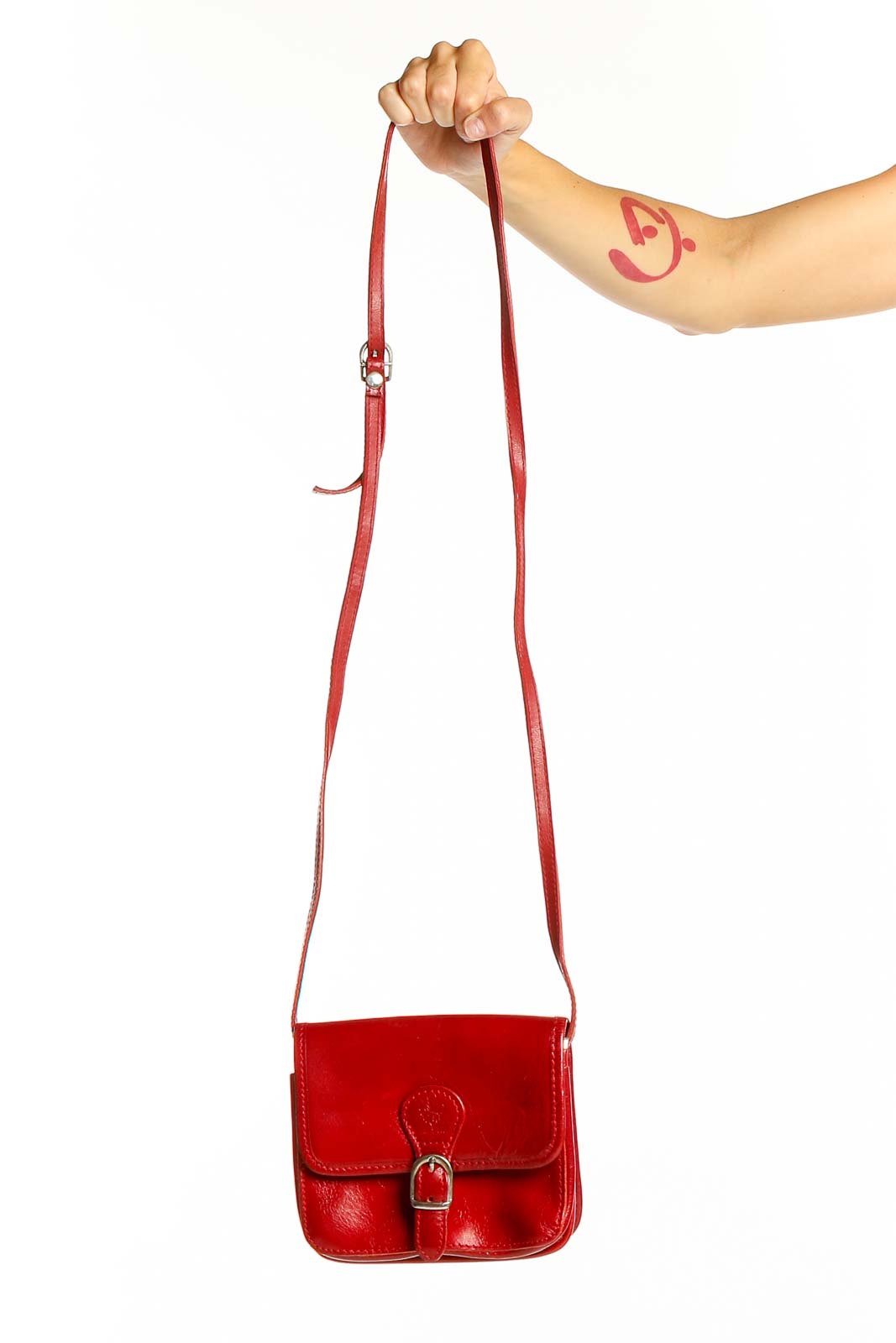 Front view of red leather Vera Pelle crossbody bag with buckle closure