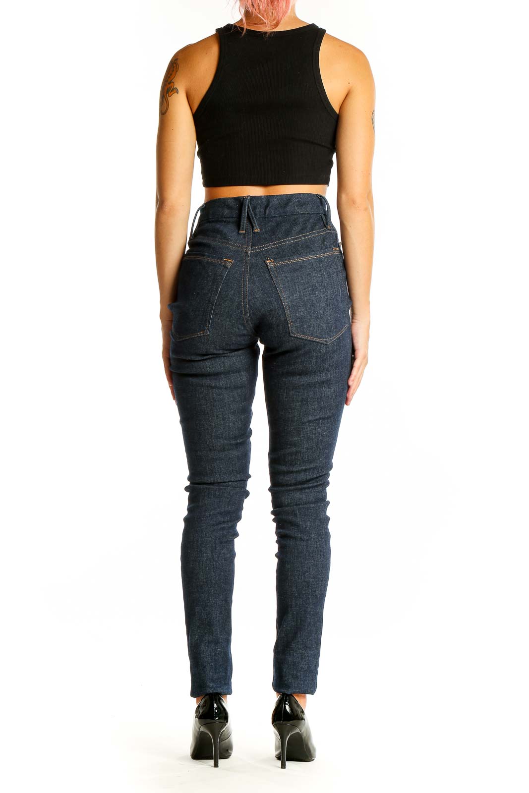 Back view of Good American dark blue high-waisted skinny jeans on model