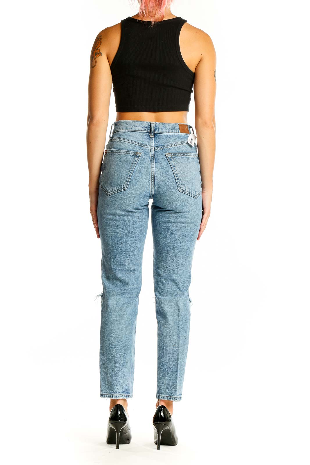 Back view of BDG light blue distressed high-waisted jeans showing pocket design