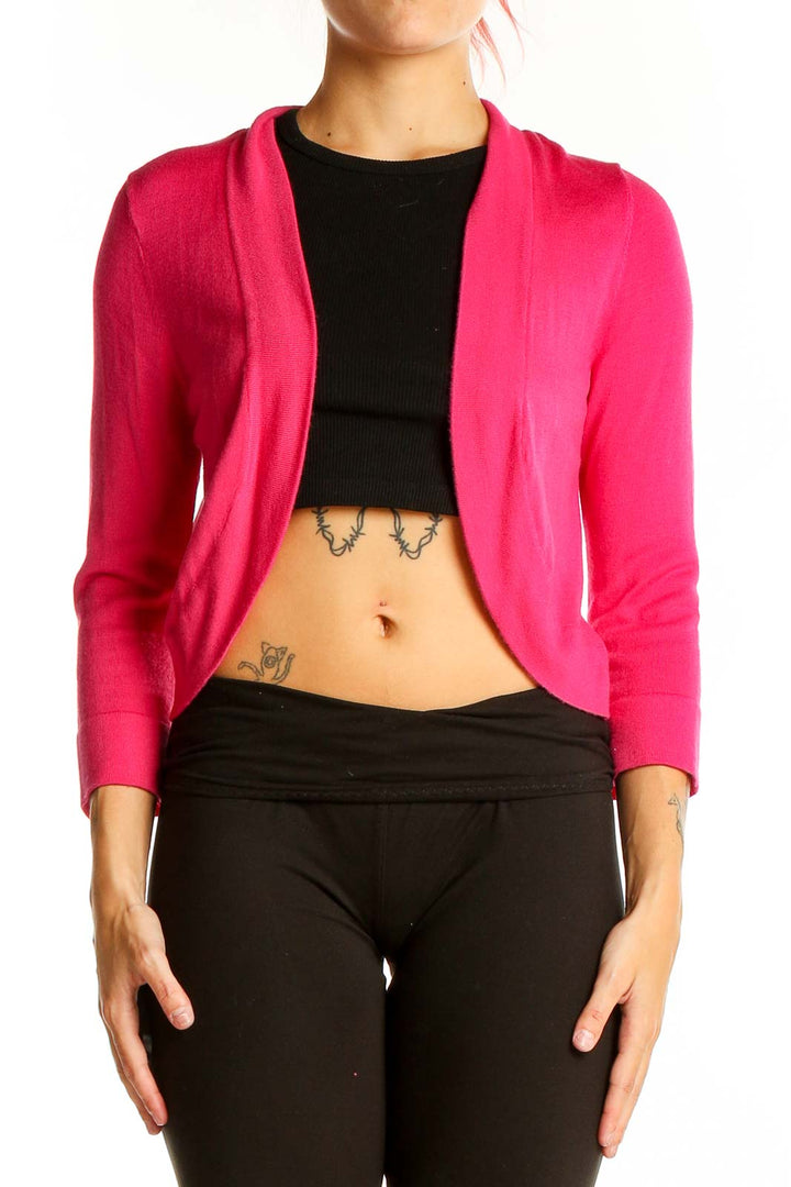 Front view of hot pink cropped cardigan sweater with open front design