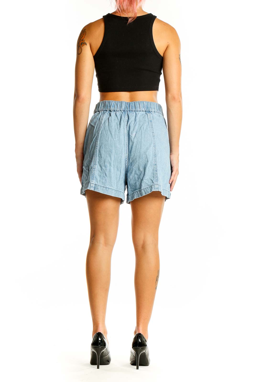 Back view of Madewell light blue denim shorts on model