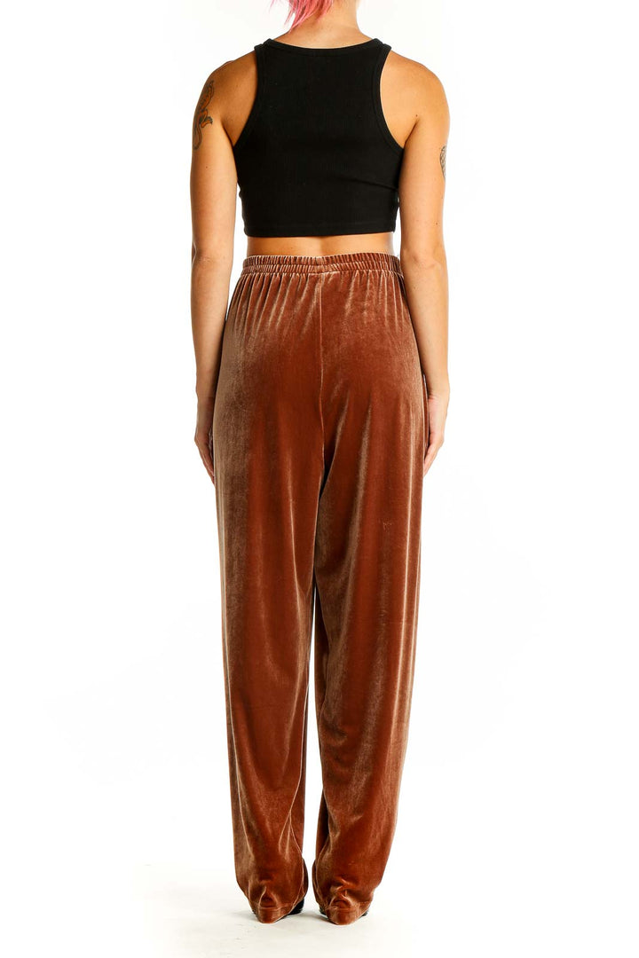 Back view of Maggie Sweet rust velvet wide-leg lounge pants on model