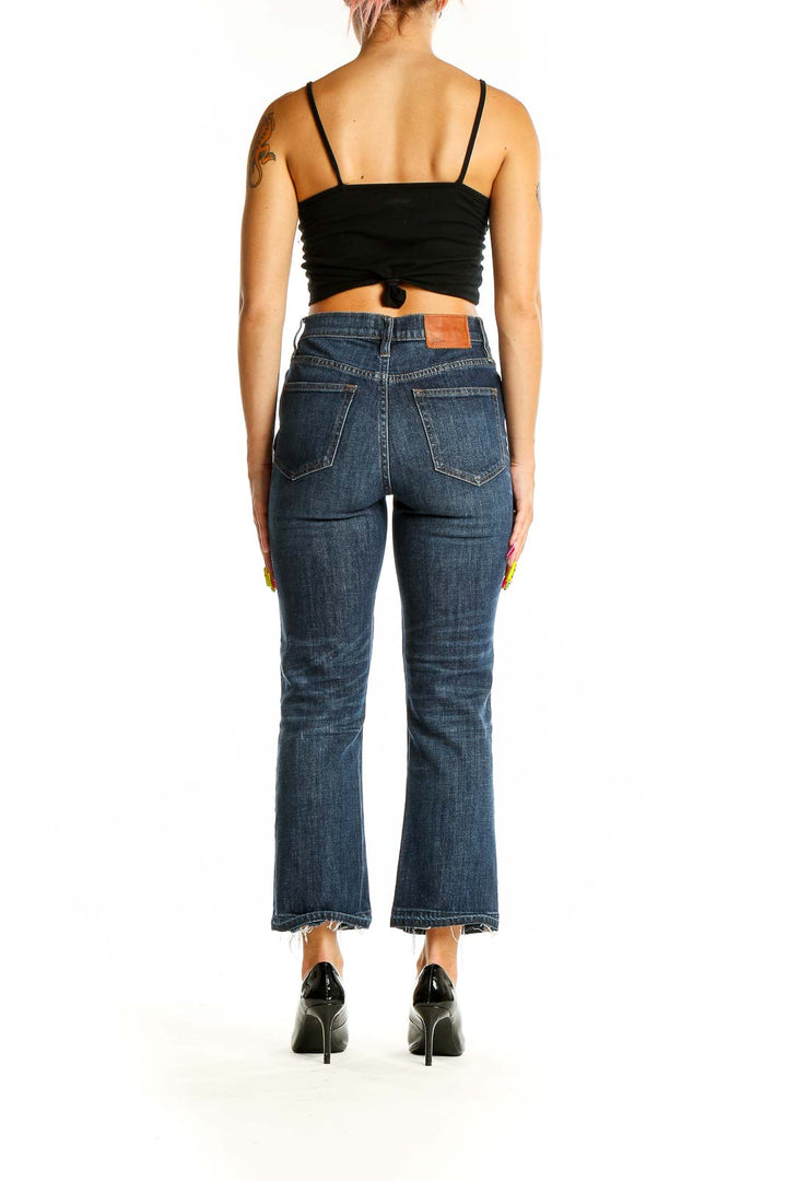 Back view of J.Crew dark blue cropped flare jeans on model