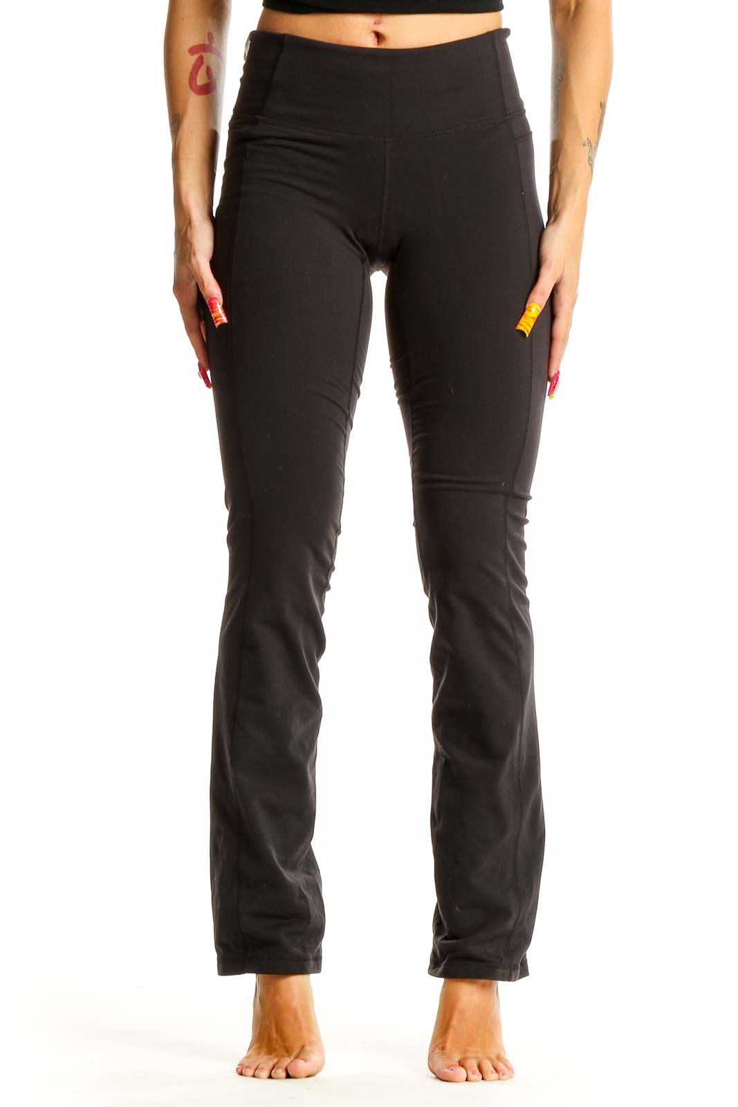 Front view of black Athleta yoga pants on model