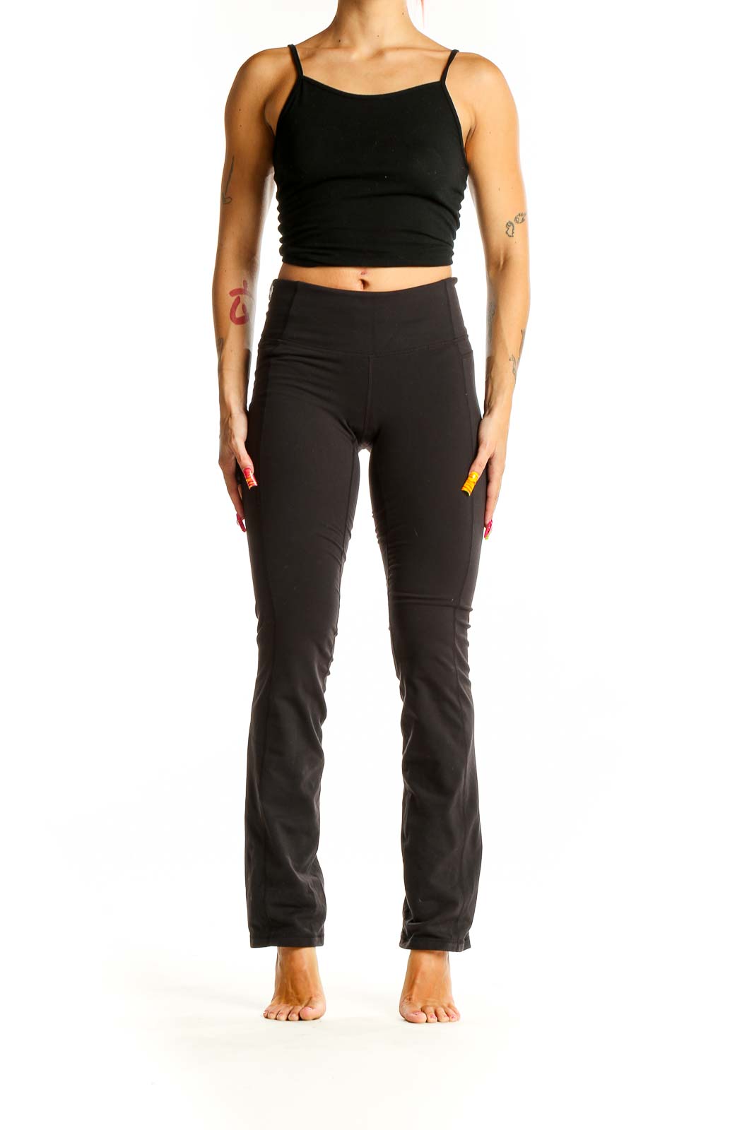 Front view of black Athleta yoga pants on model