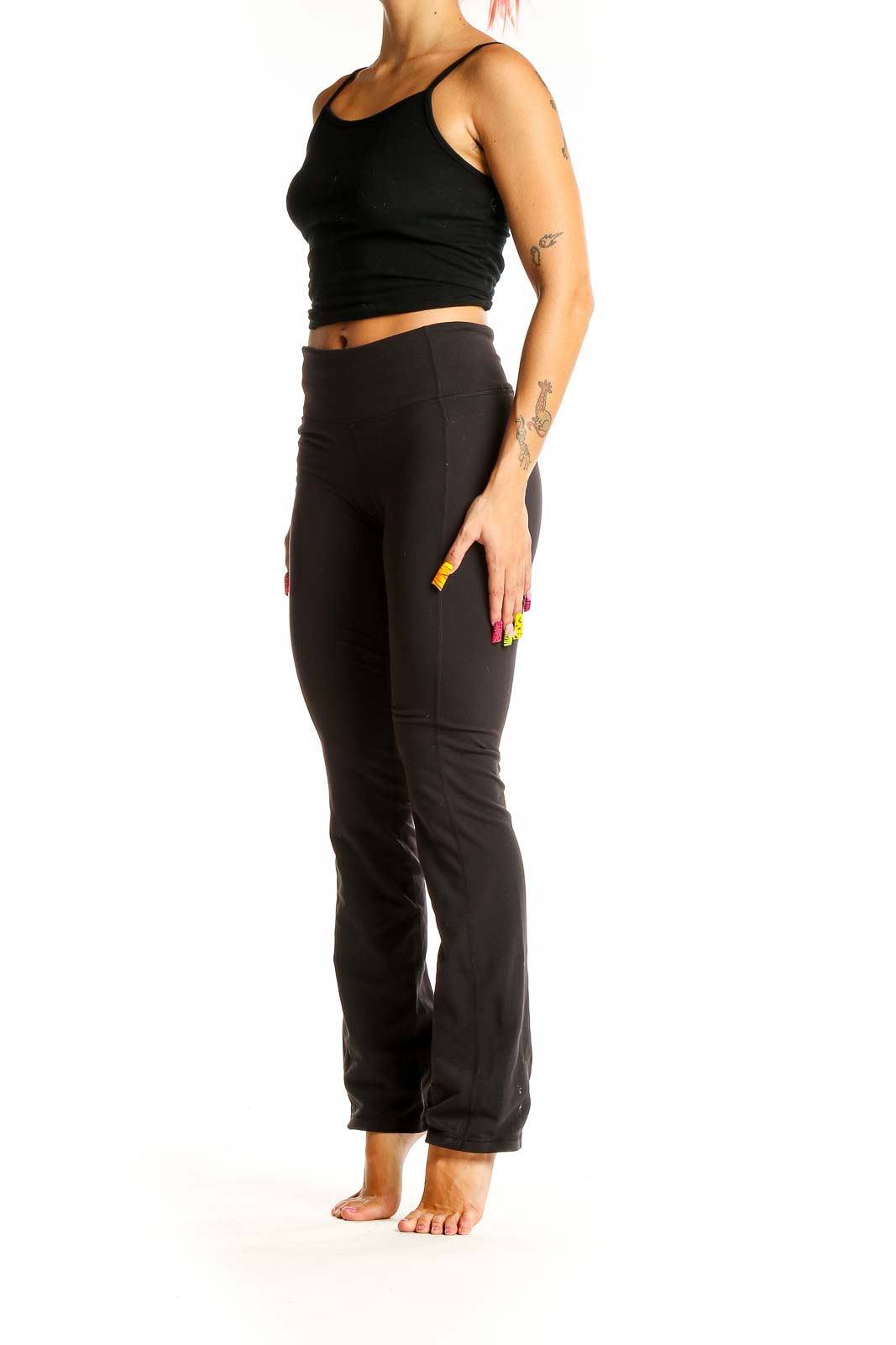 Front view of black Athleta yoga pants on model