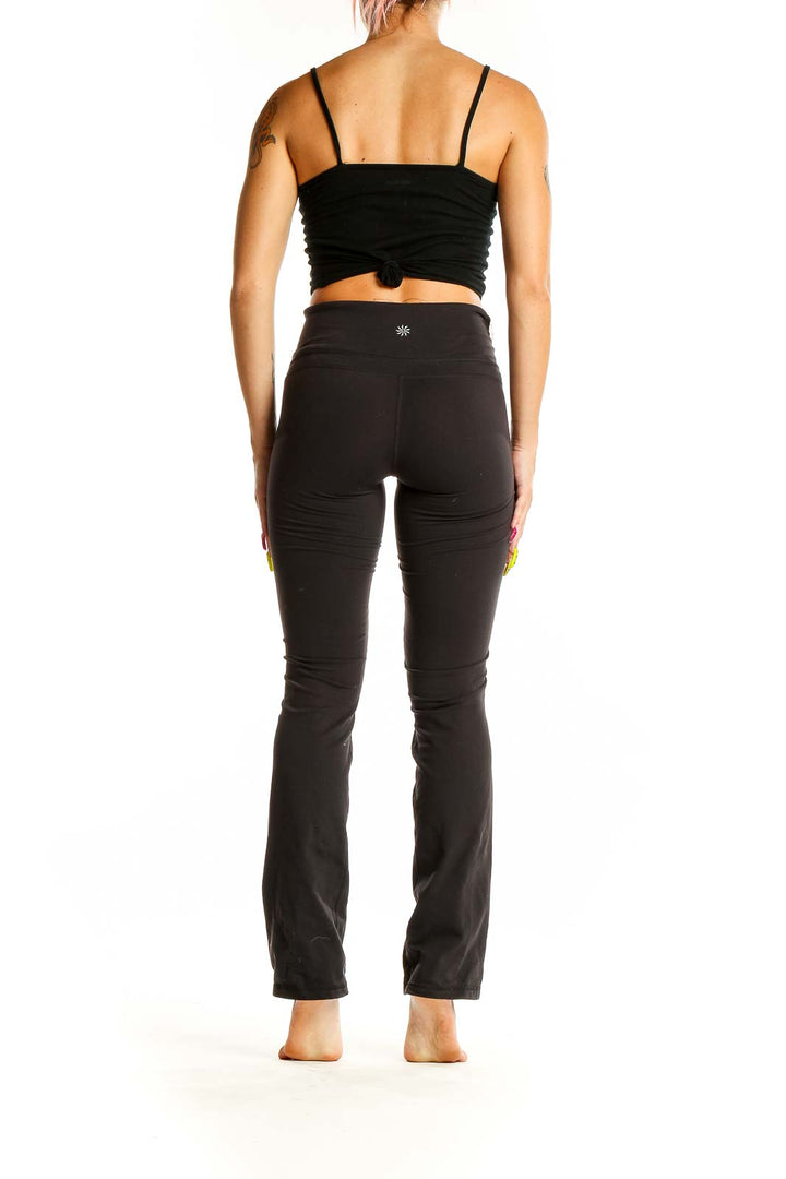 Back view of black Athleta yoga pants on model