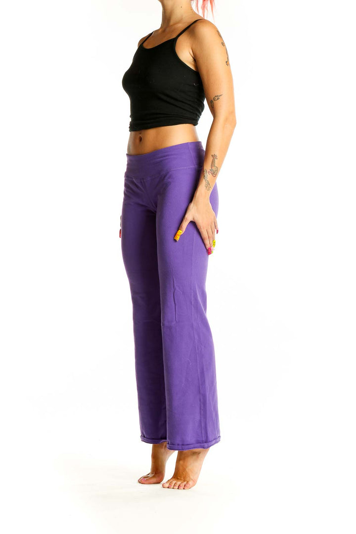 Front view of purple flared yoga pants from Beyond Yoga