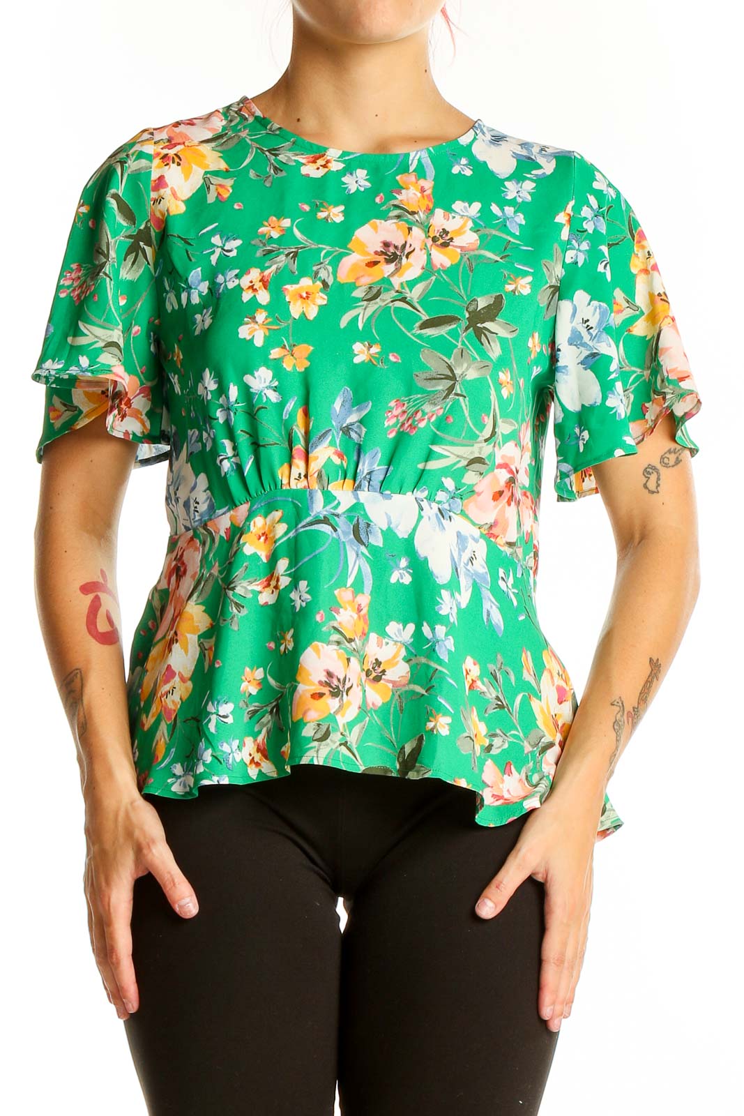 Front view of LOFT green floral peplum top with flutter sleeves