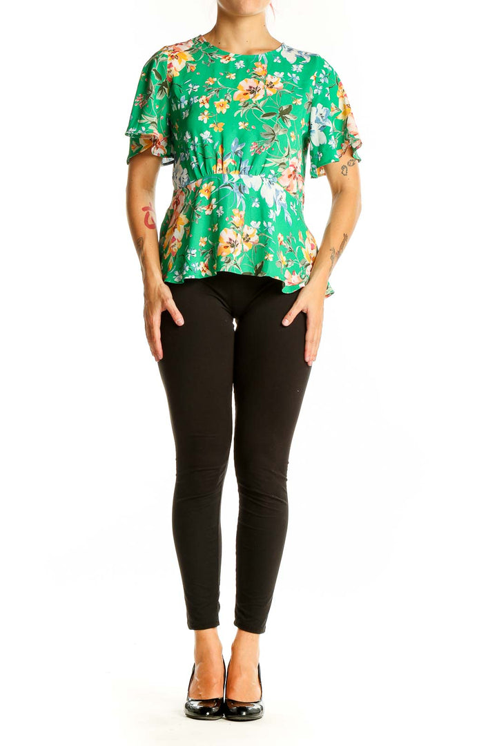 Front view of LOFT green floral peplum top with flutter sleeves