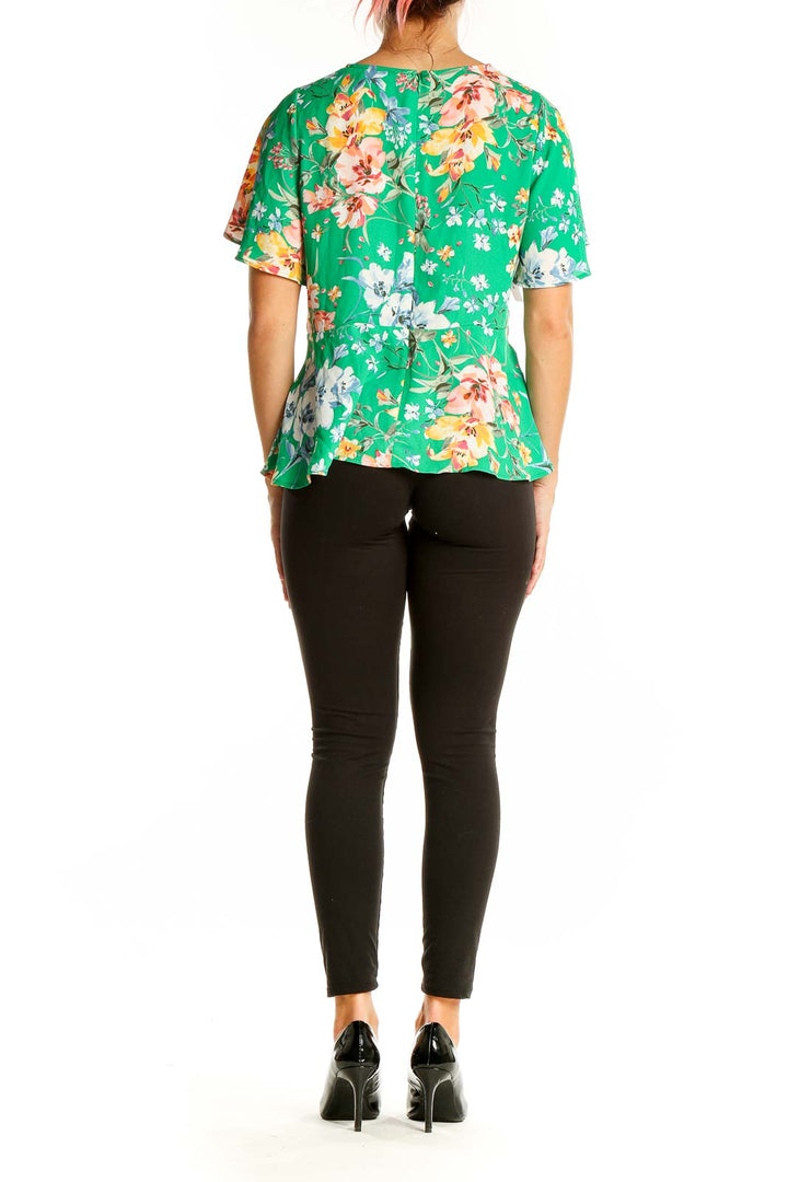 Back view of LOFT green floral peplum top showing all-over print