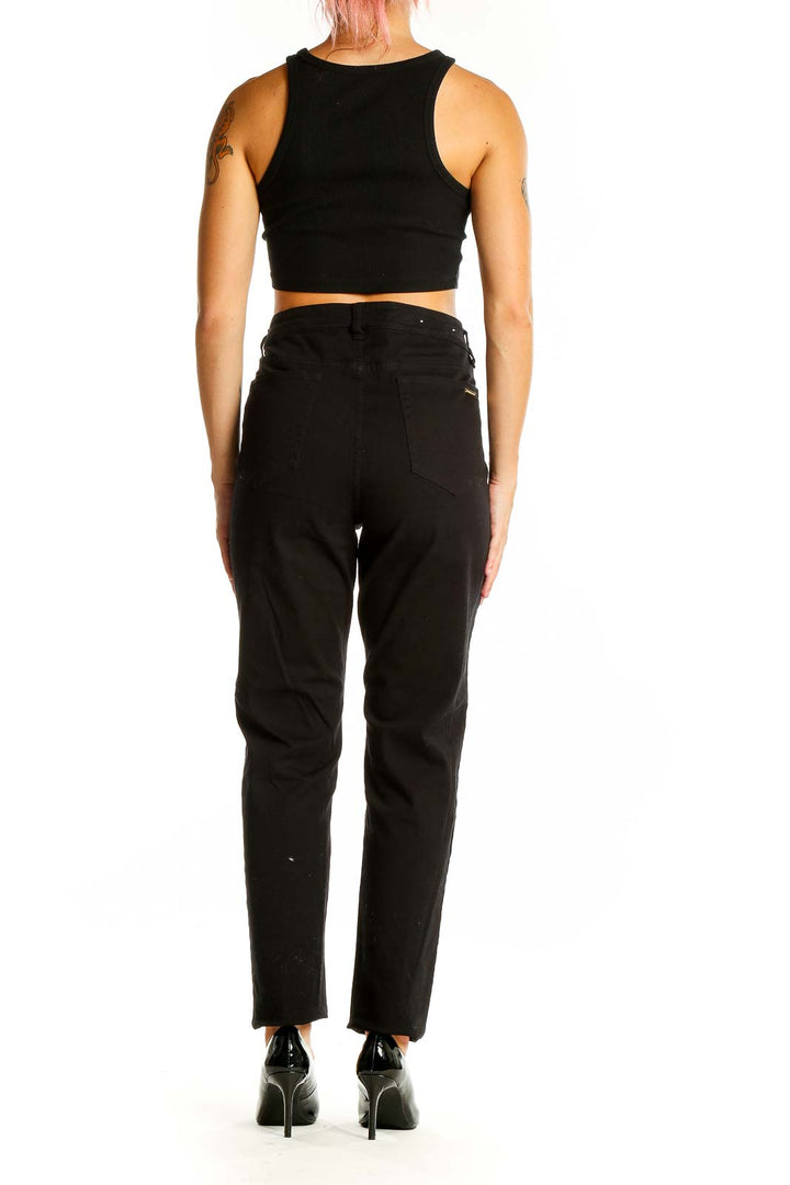 Back view of Michael Kors black high-waisted straight-leg jeans on model