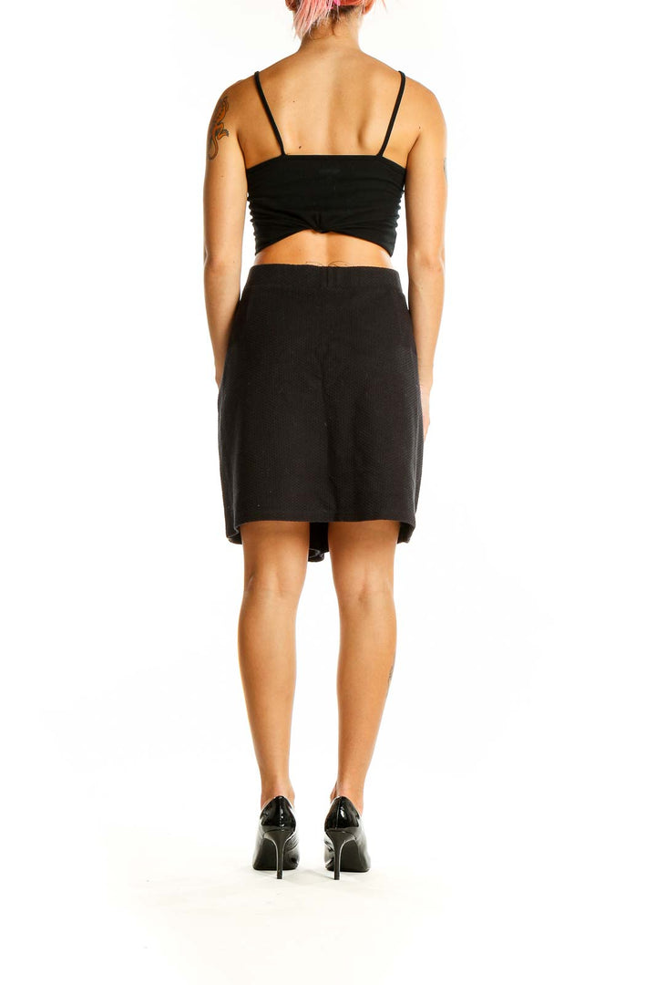 Back view of Joules black textured A-line mini skirt on model