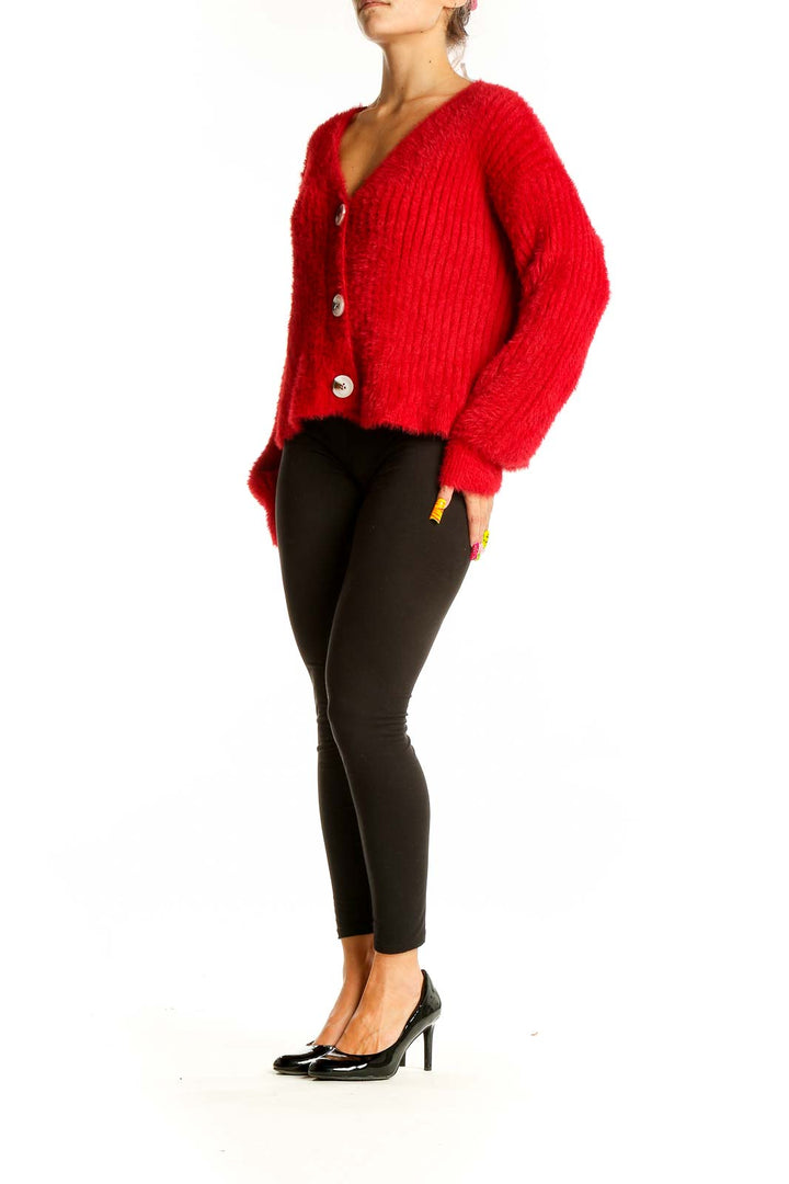 Front view of red fuzzy MINKPINK cardigan with oversized white buttons