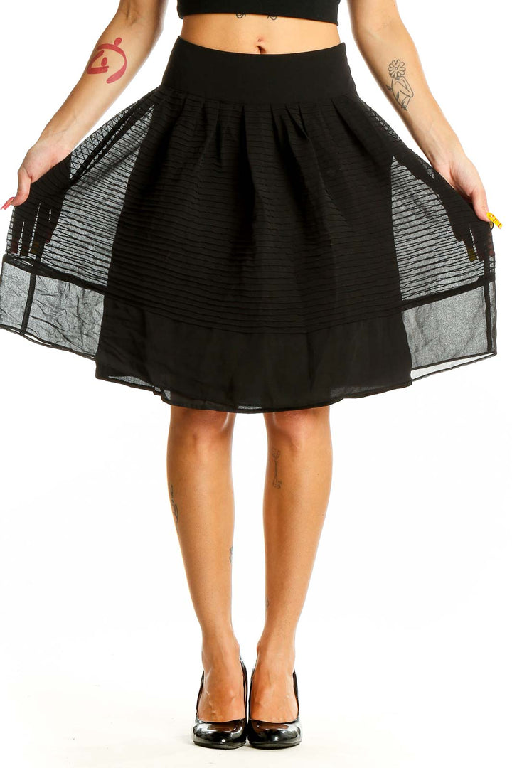 Front view of Ann Taylor black pleated A-line skirt with sheer overlay