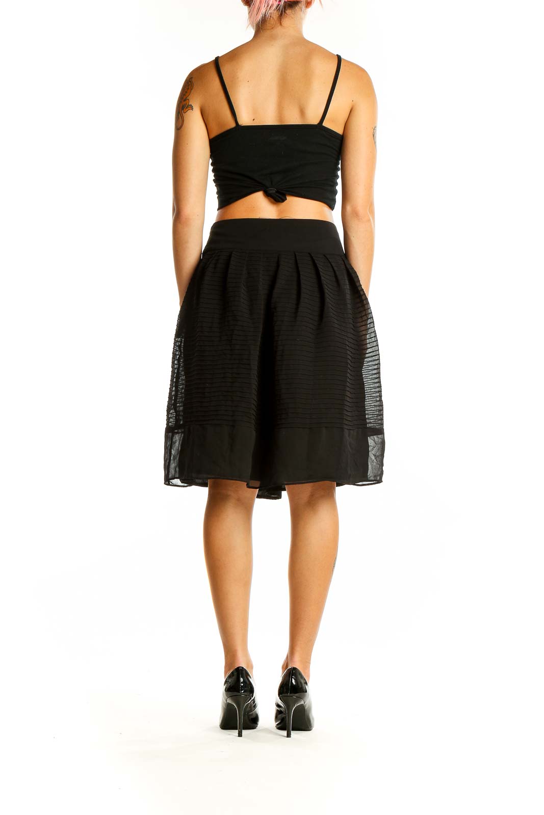 Back view of Ann Taylor black pleated A-line skirt with sheer overlay