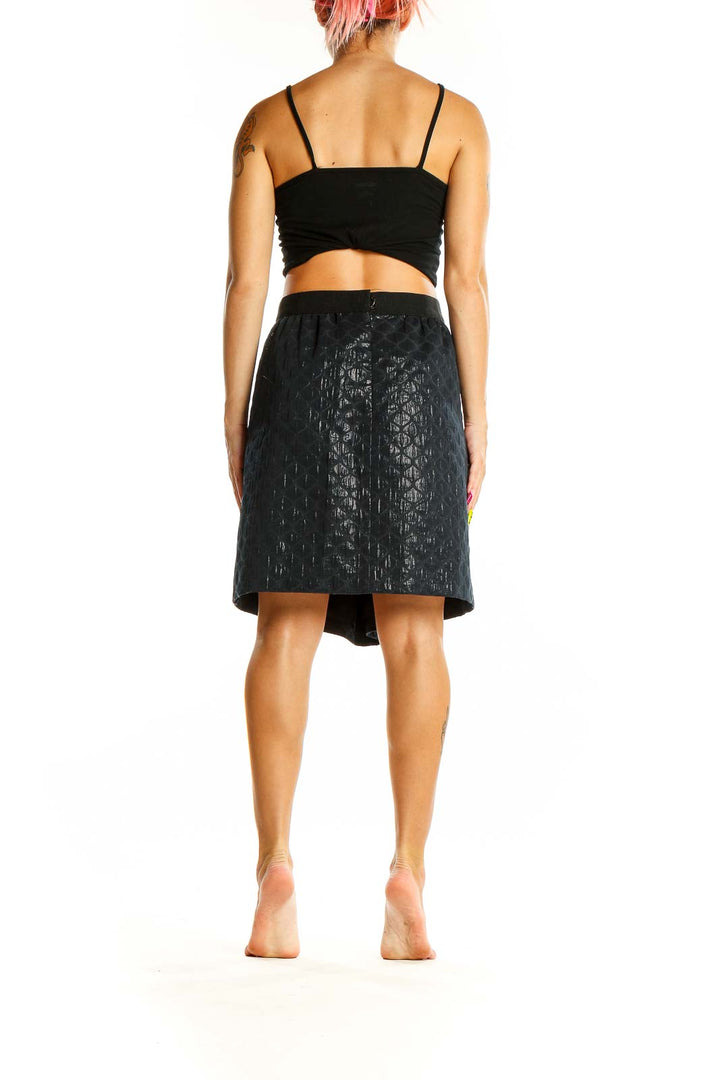 Back view of Ann Taylor LOFT black metallic textured A-line skirt on model