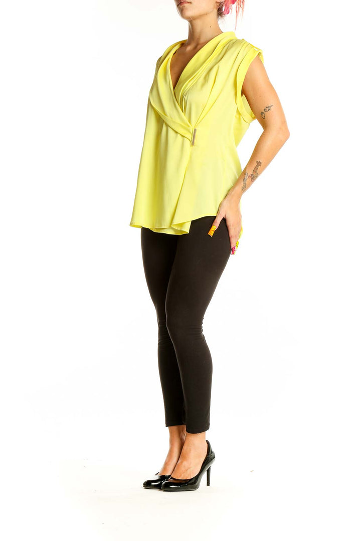 Front view of Ann Taylor yellow sleeveless wrap blouse on model