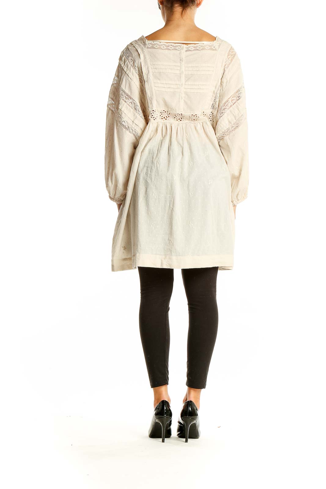 Back view of cream lace cotton dress from Free People showing flowy silhouette and eyelet embroidery