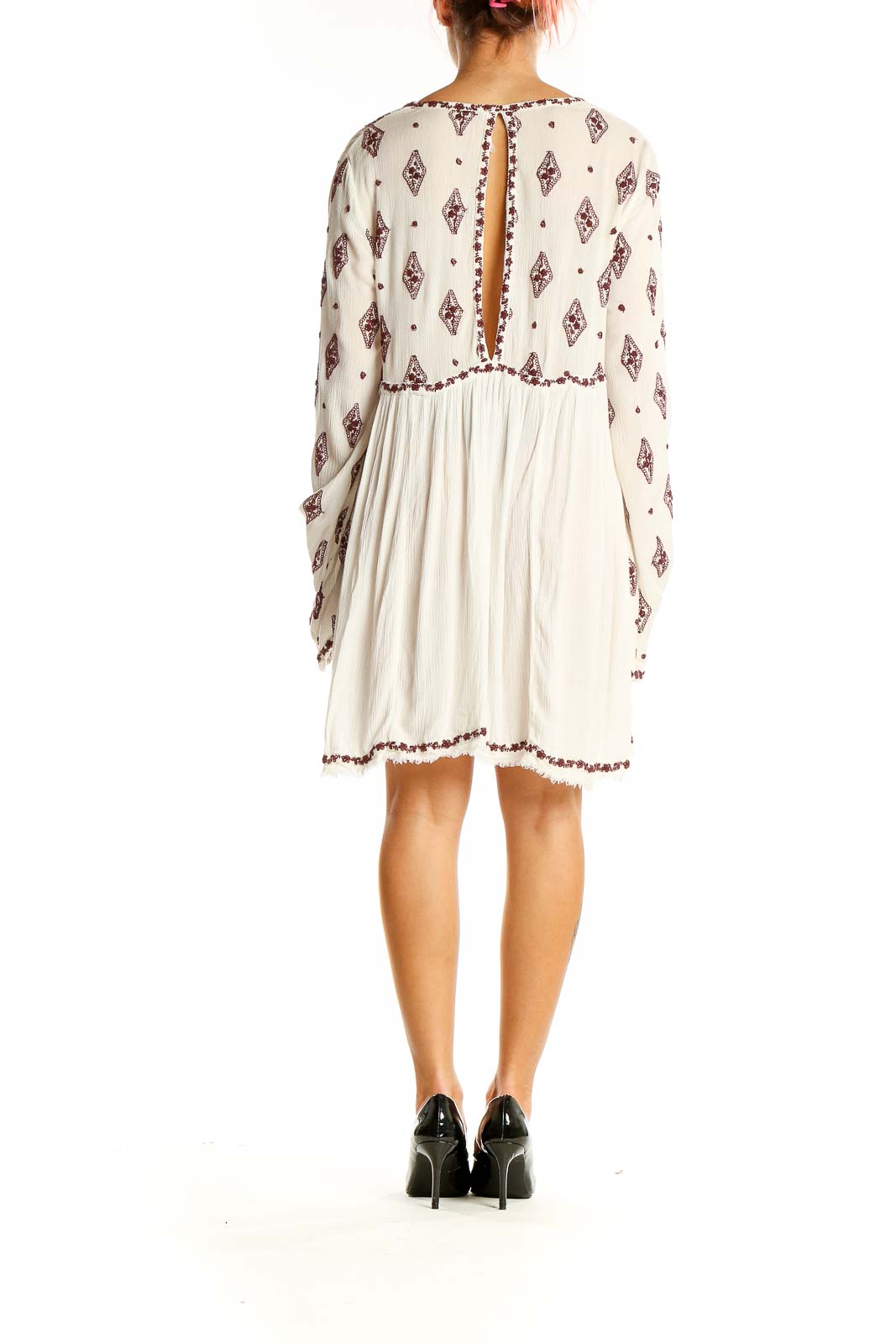 Back view of white Free People boho mini dress showing keyhole closure and flowy silhouette