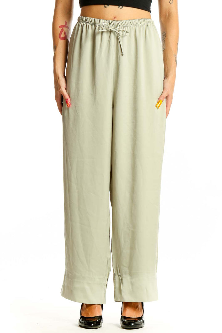 Front view of sage green Uniqlo wide-leg pants with drawstring waist