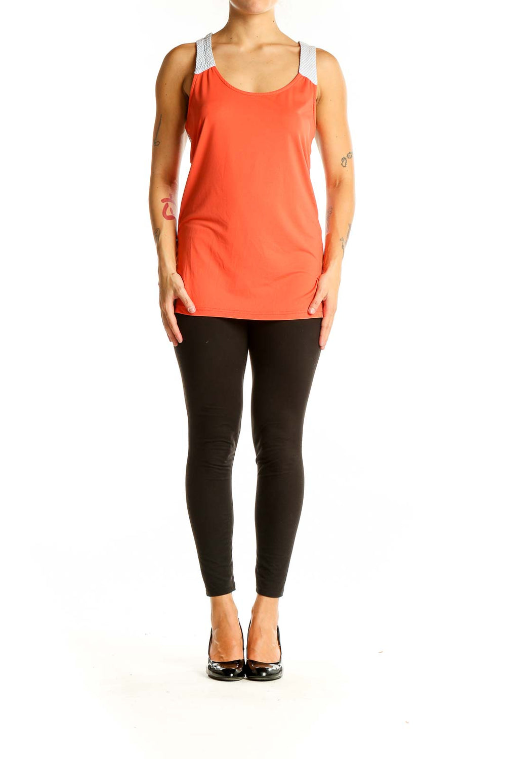 Front view of coral athletic tank top with white mesh straps