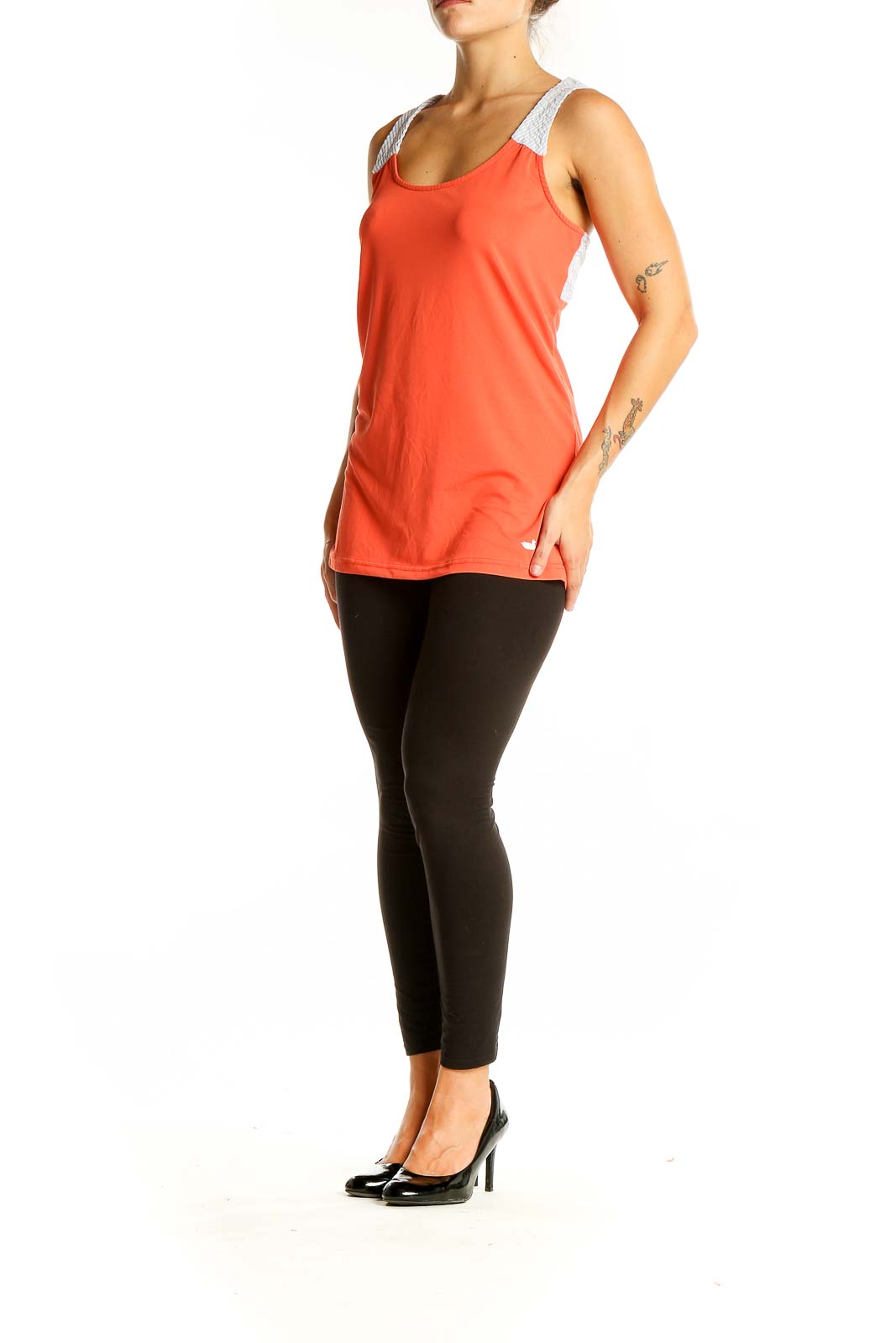 Front view of coral athletic tank top with white mesh straps